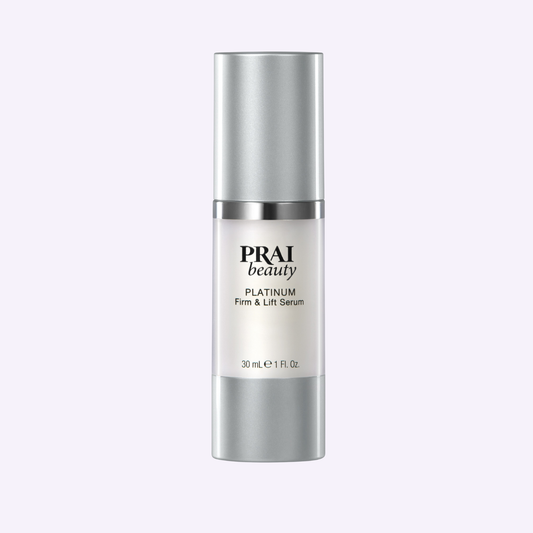 Serum bottle with silver cap and PRAI beauty Platinum Firm & Lift Serum label, 30 mL