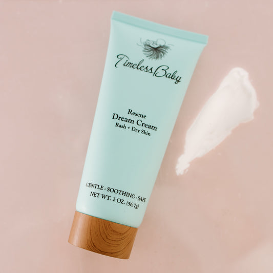 Timeless Baby Dream Cream tube, light blue with wood cap; cream smear near surface