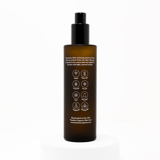 Hydrating face & body mist bottle with black pump, amber bottle, back label icons