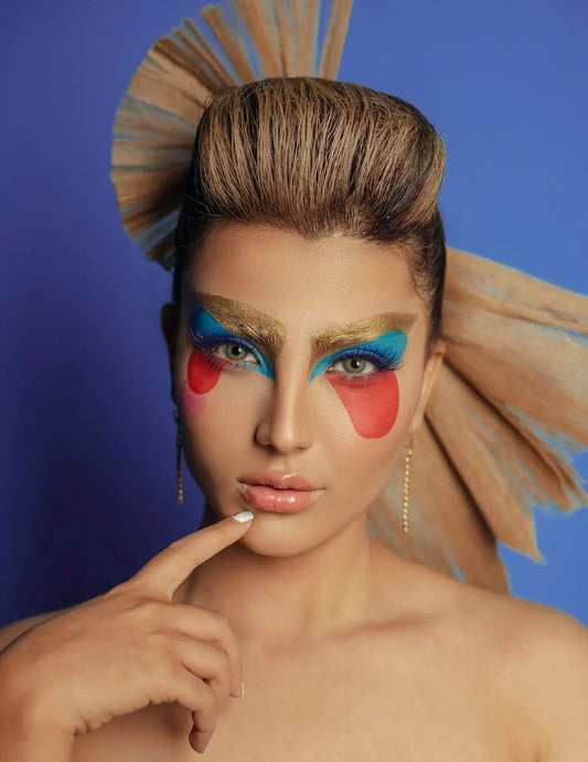 a woman with makeup and feathers on her head
