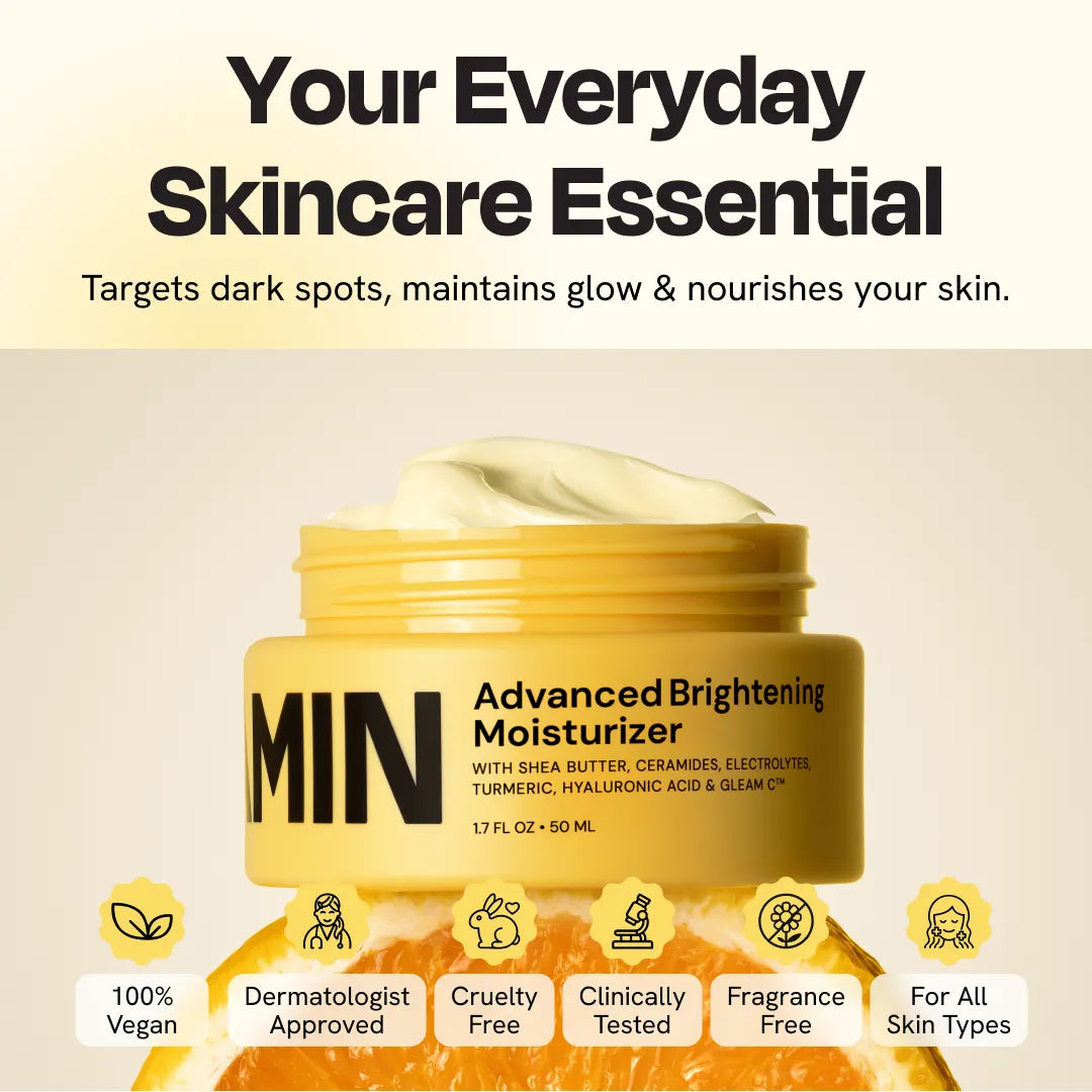Yellow face moisturizer jar with a scoop of white cream on top and silver lid