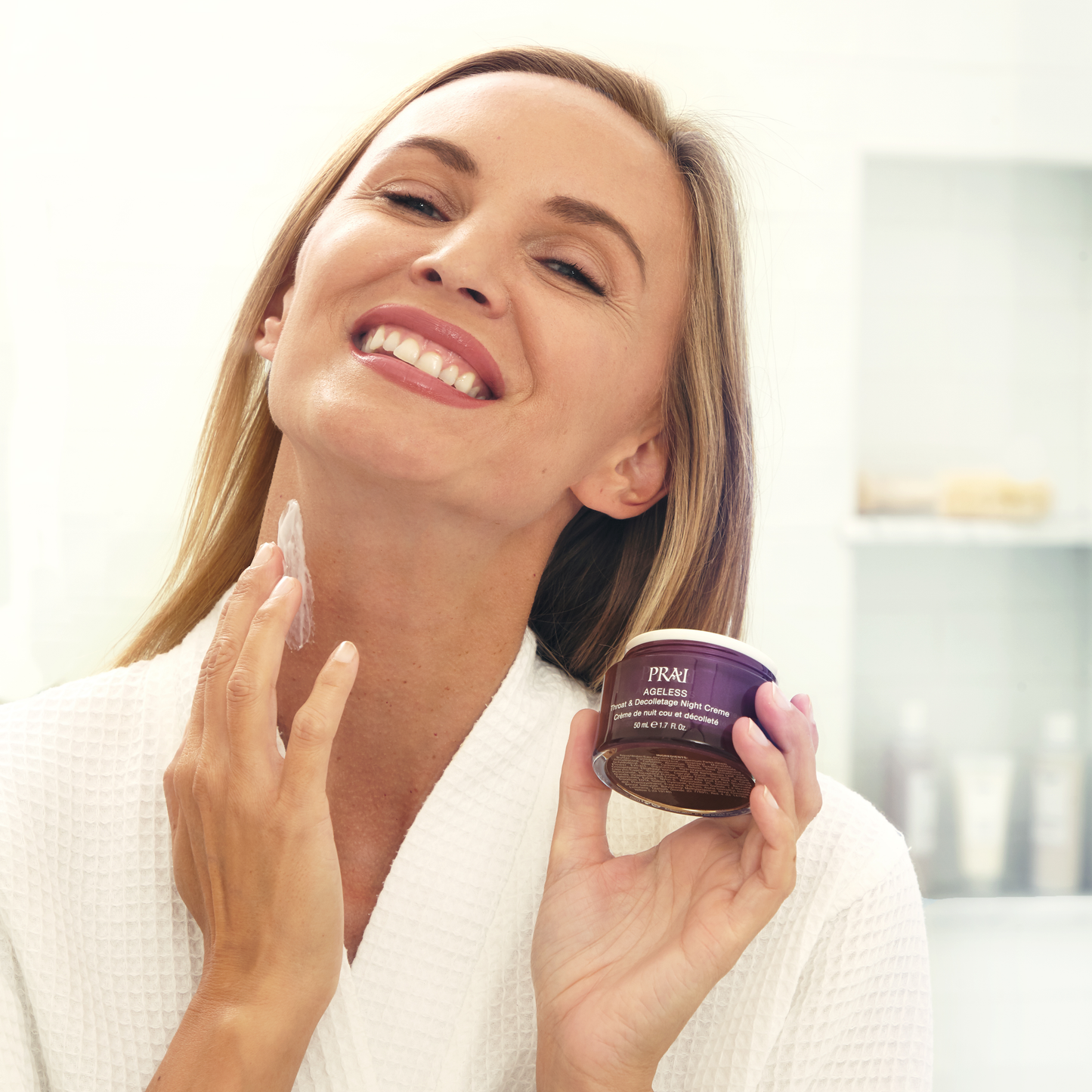 Woman applying Ageless throat & décolletage night creme from purple jar