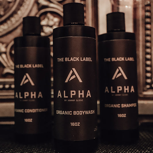 Group of three Alpha body wash bottles, black pump dispensers with charcoal label
