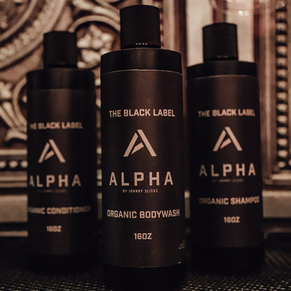 Group of three Alpha body wash bottles, black pump dispensers with charcoal label