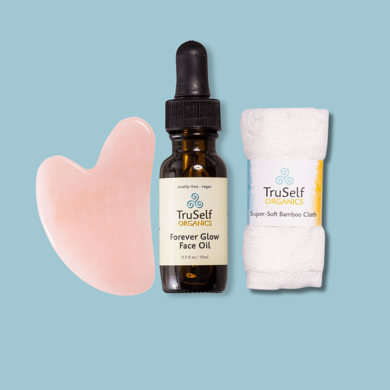 Anti-aging facial massage kit set with rose quartz gua sha, face oil, and super-soft bamboo cloth