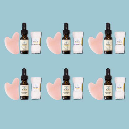 Anti-aging facial massage kit shown in rows: rose quartz gua sha, face oil bottle, bamboo cloth