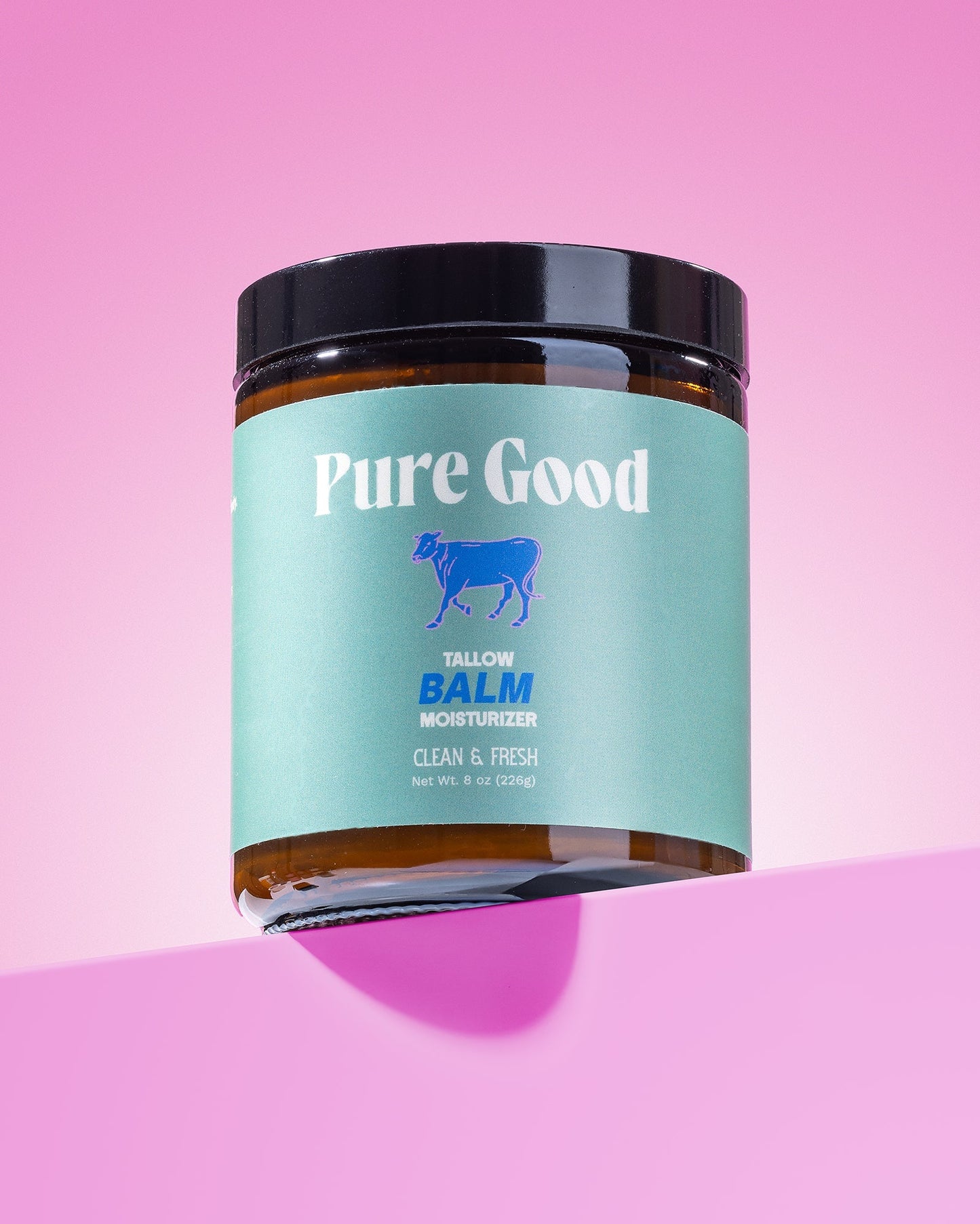 Tallow balm jar with black lid and teal label reading Clean & Fresh.