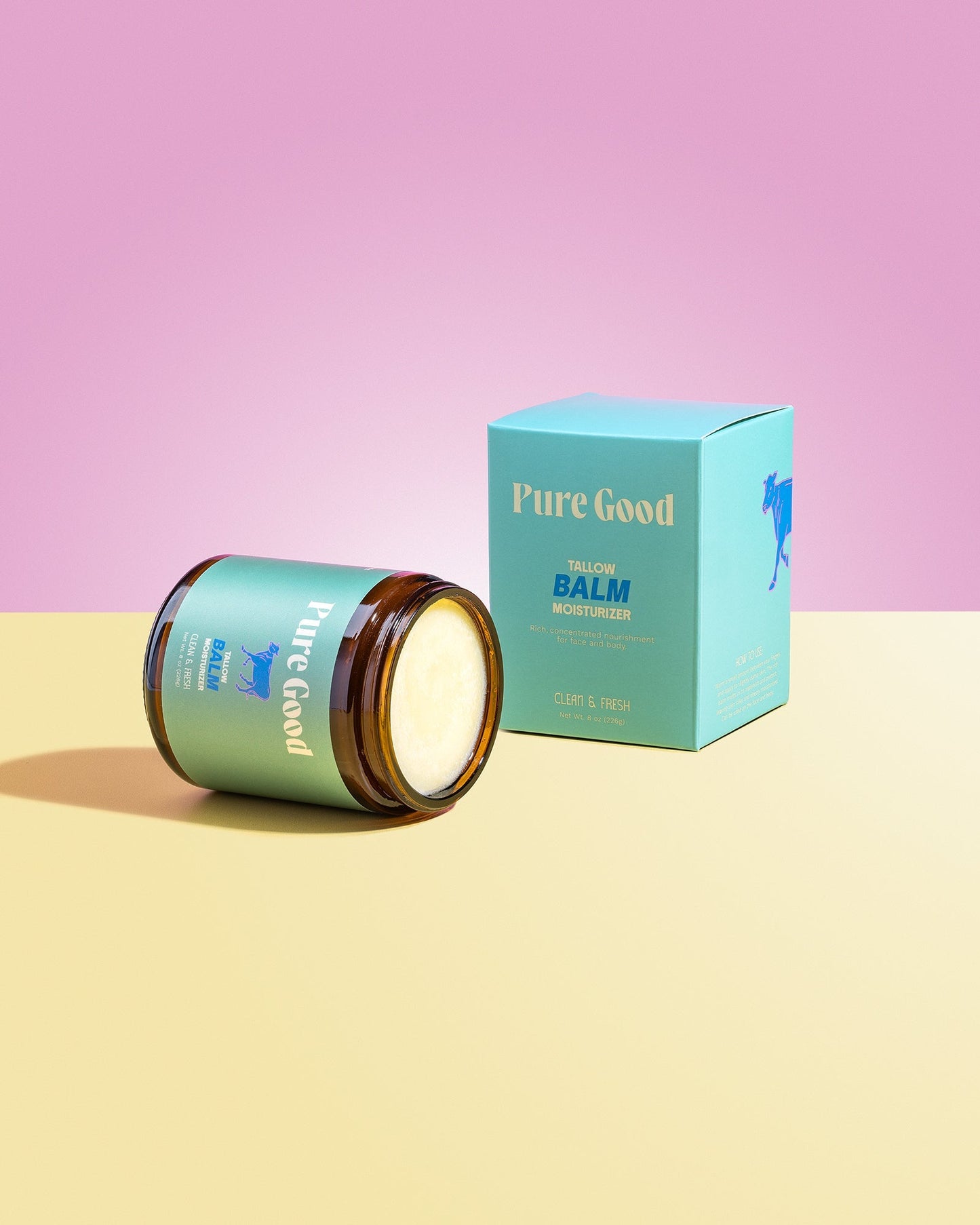 Tallow balm jar, open with creamy pale yellow balm visible.