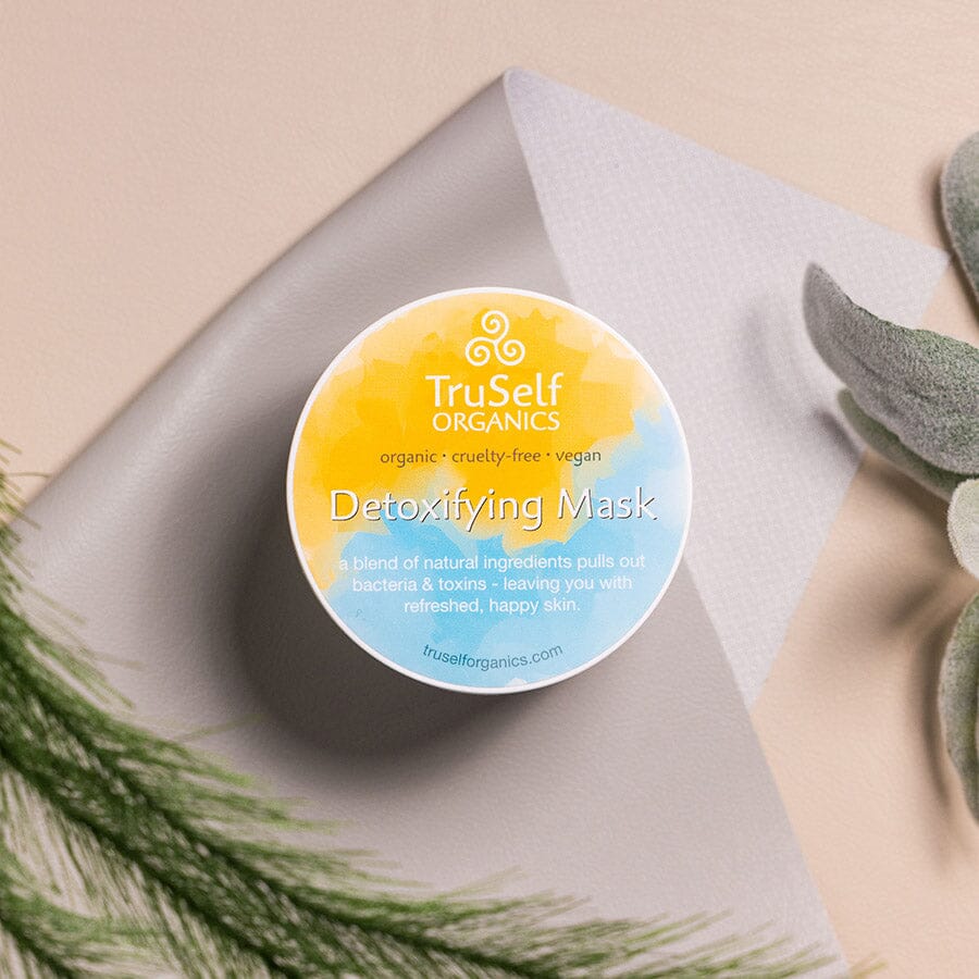 Detoxifying mask jar lid with TruSelf Organics yellow-blue label and Detoxifying Mask text