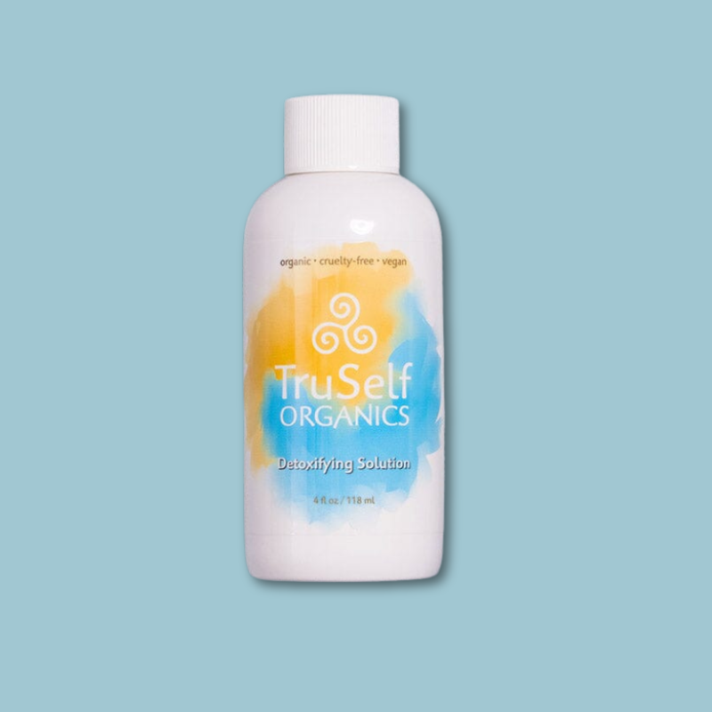 Detoxifying solution bottle, front view with orange-blue swirl label and ribbed cap