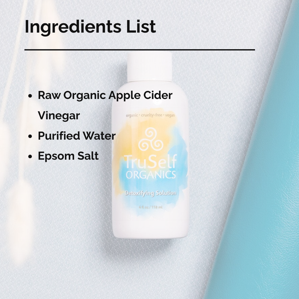 Detoxifying solution bottle with ingredients list text on left; white bottle and ribbed cap