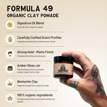 Organic clay pomade jar with black lid held in a hand, tan Formula 49 label