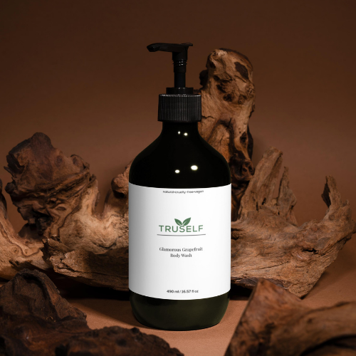 Body wash bottle with black pump, dark green bottle, white grapefruit label