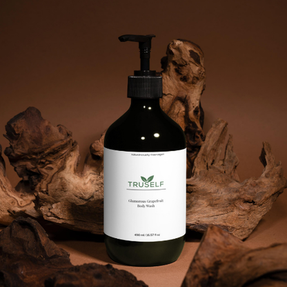 Body wash bottle with black pump, dark green bottle, white grapefruit label
