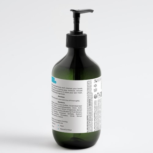Body wash bottle with black pump, dark green bottle, ingredient label on back