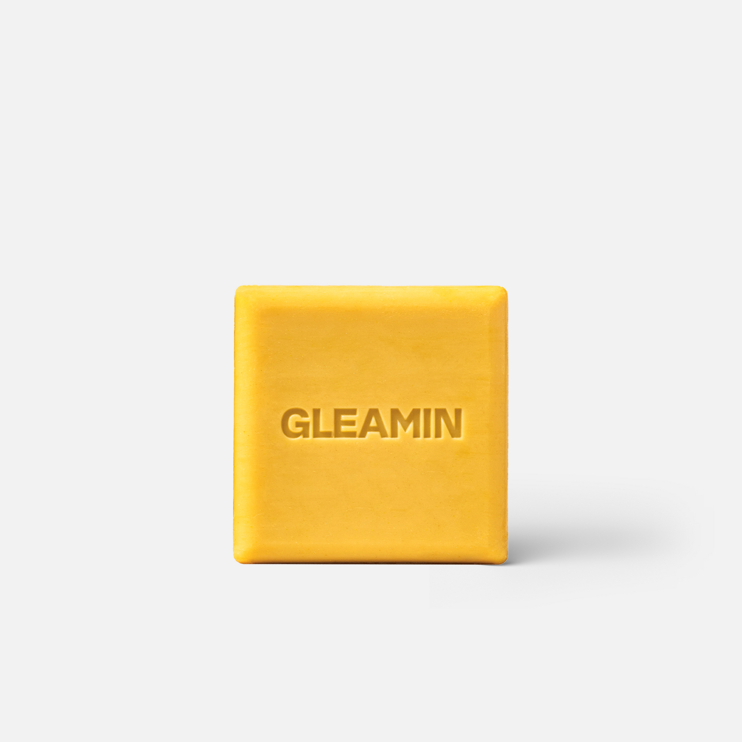 Brightening cleansing bar, square yellow-gold soap with GLEAMIN imprint