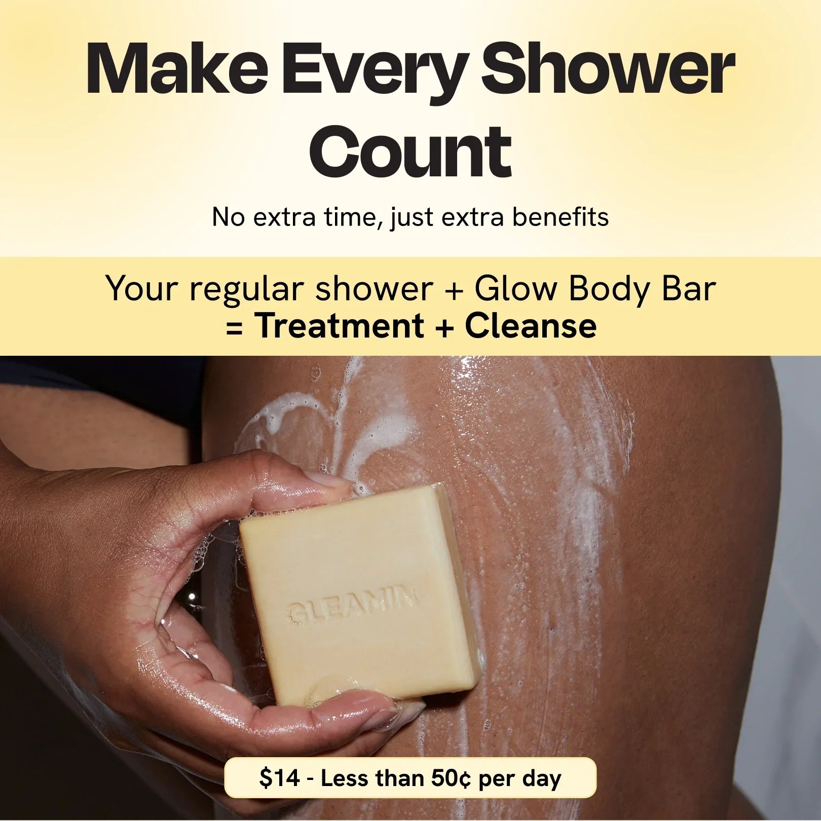 Cleansing bar with lather on skin, square pale yellow soap with GLEAMIN imprint