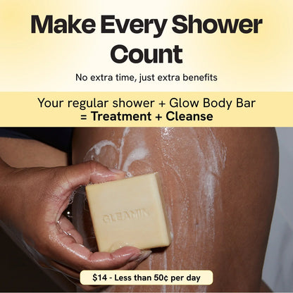 Cleansing bar with lather on skin, square pale yellow soap with GLEAMIN imprint