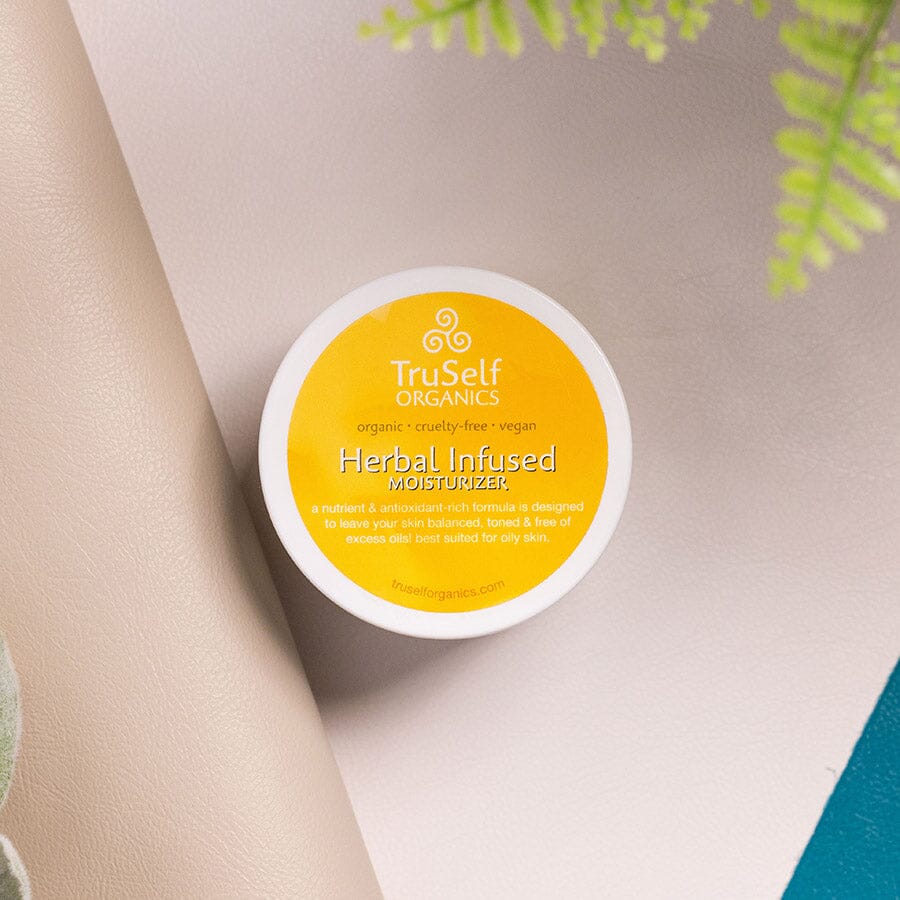 Herbal infused moisturizer lid with yellow label and TruSelf ORGANICS branding