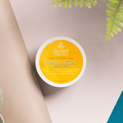 Herbal infused moisturizer lid with yellow label and TruSelf ORGANICS branding