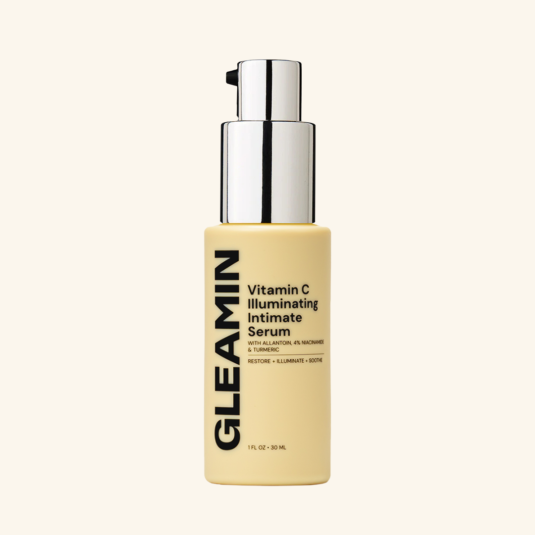Vitamin C illuminating intimate serum bottle with silver pump cap and cream liquid
