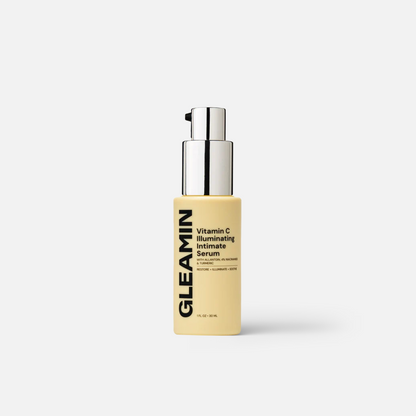 Serum bottle with chrome pump and pale beige label, illuminated finish.