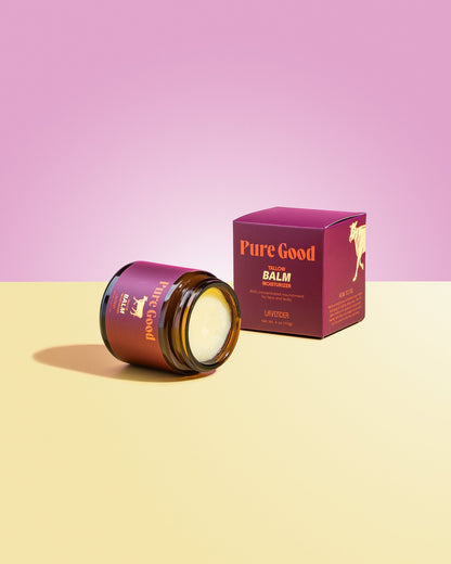 Tallow balm jar with open lid and pale cream balm, next to lavender box