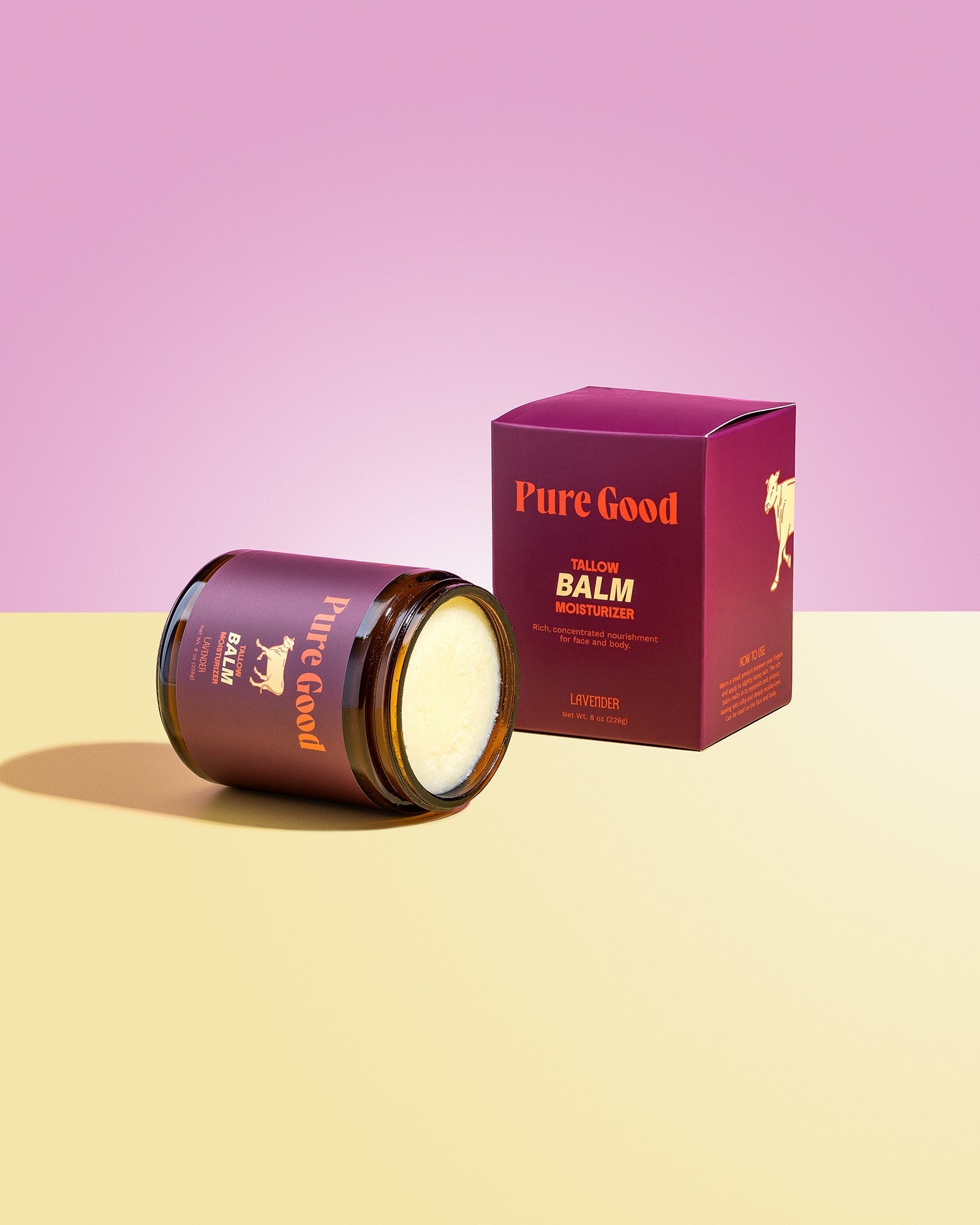 Tallow balm jar with open lid, showing pale cream balm, beside lavender box