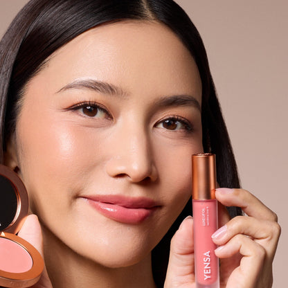 YENSA lip oil bottle held beside lips with pink tinted gloss