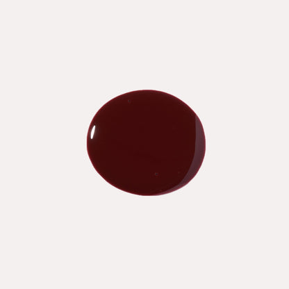 Dark maroon glossy lip oil drop swatch on light background