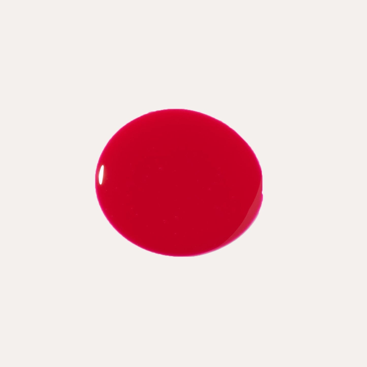 Bright red glossy lip oil drop swatch on light background