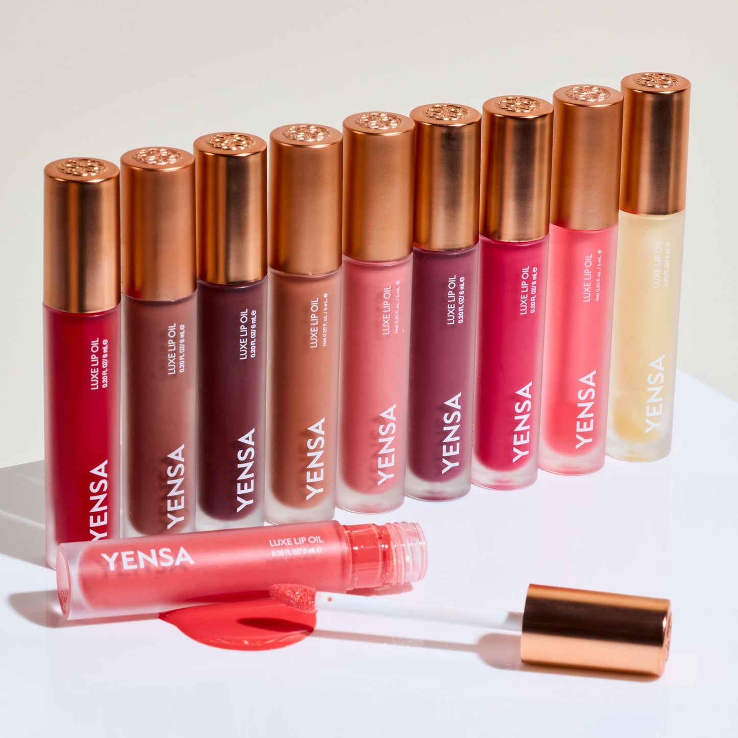 Lip nourishing oil set of tubes with rose, berry, and nude shades, plus applicator