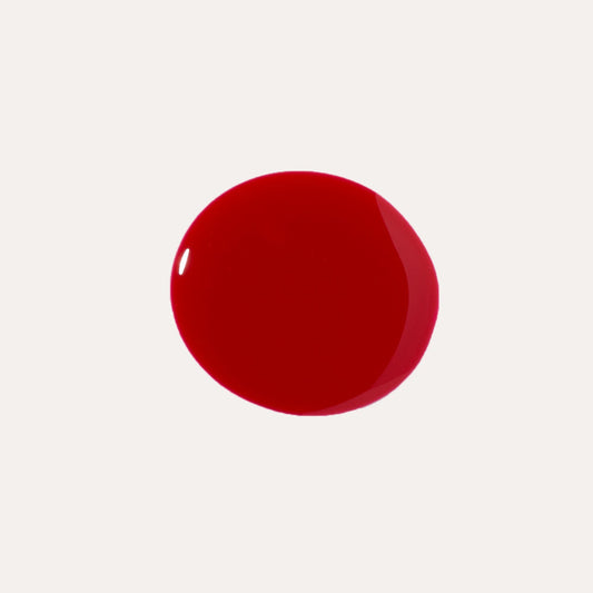 Deep red glossy lip oil drop swatch on light background