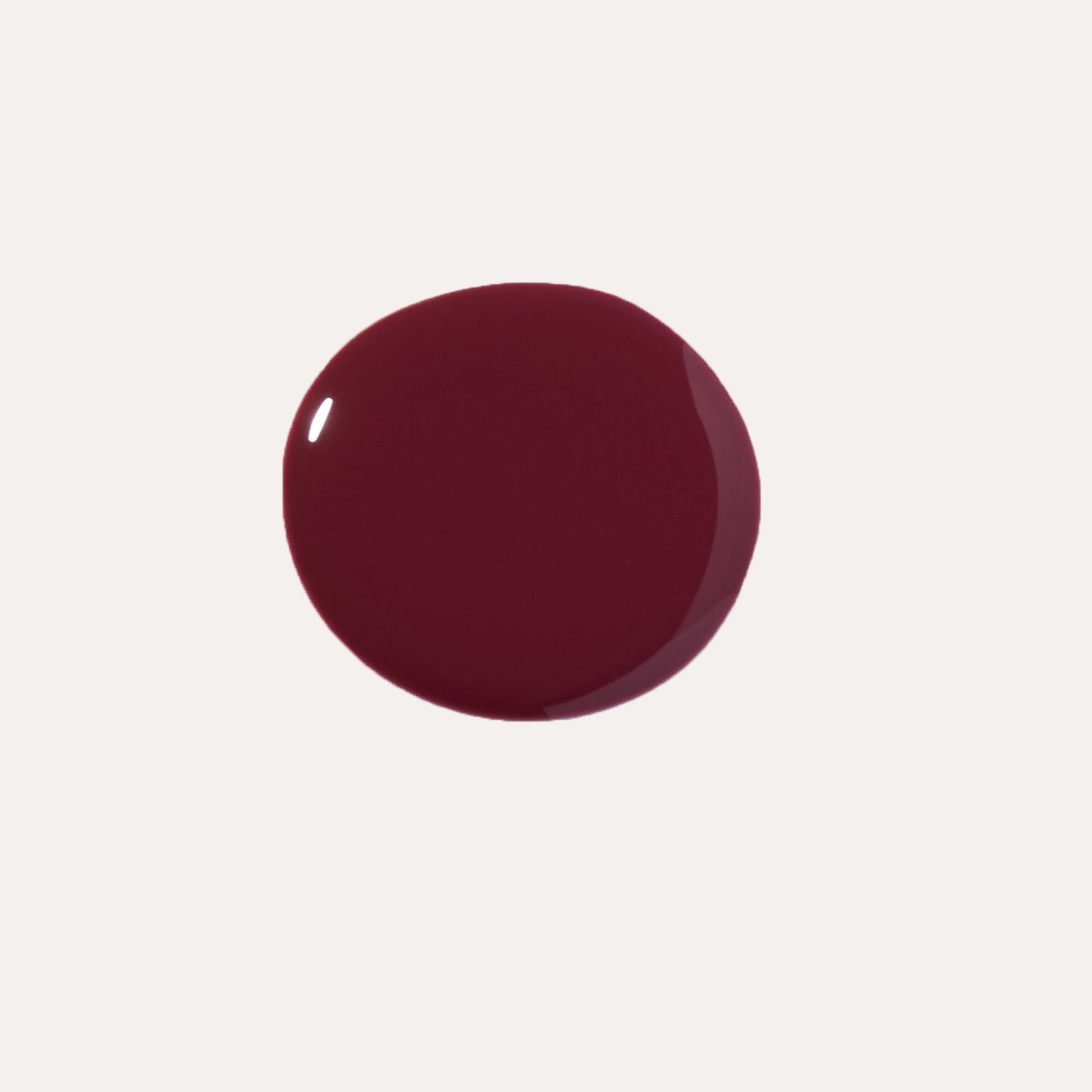 Deep burgundy lip oil gloss drop with reflective shine