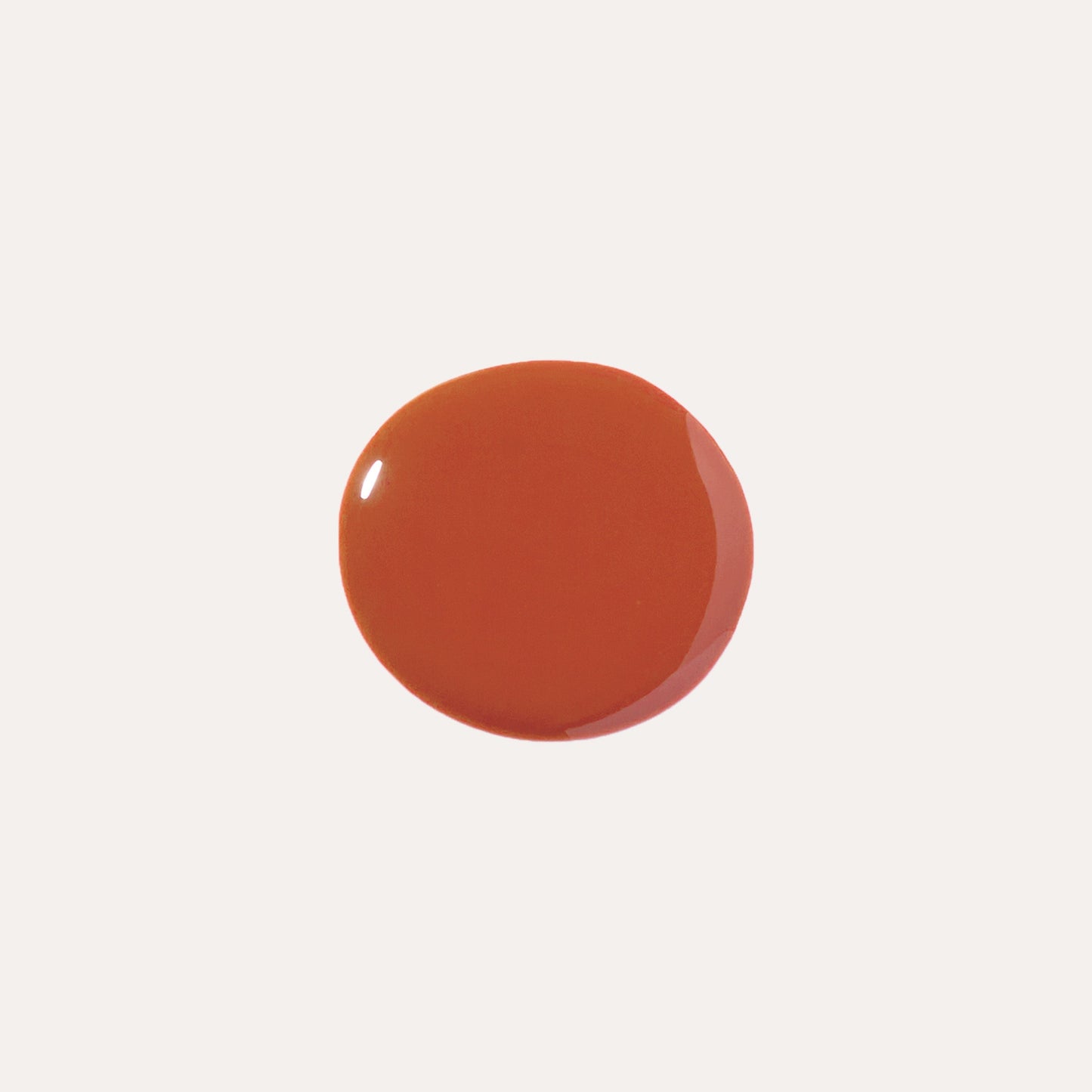 Orange-red glossy lip oil swatch circle