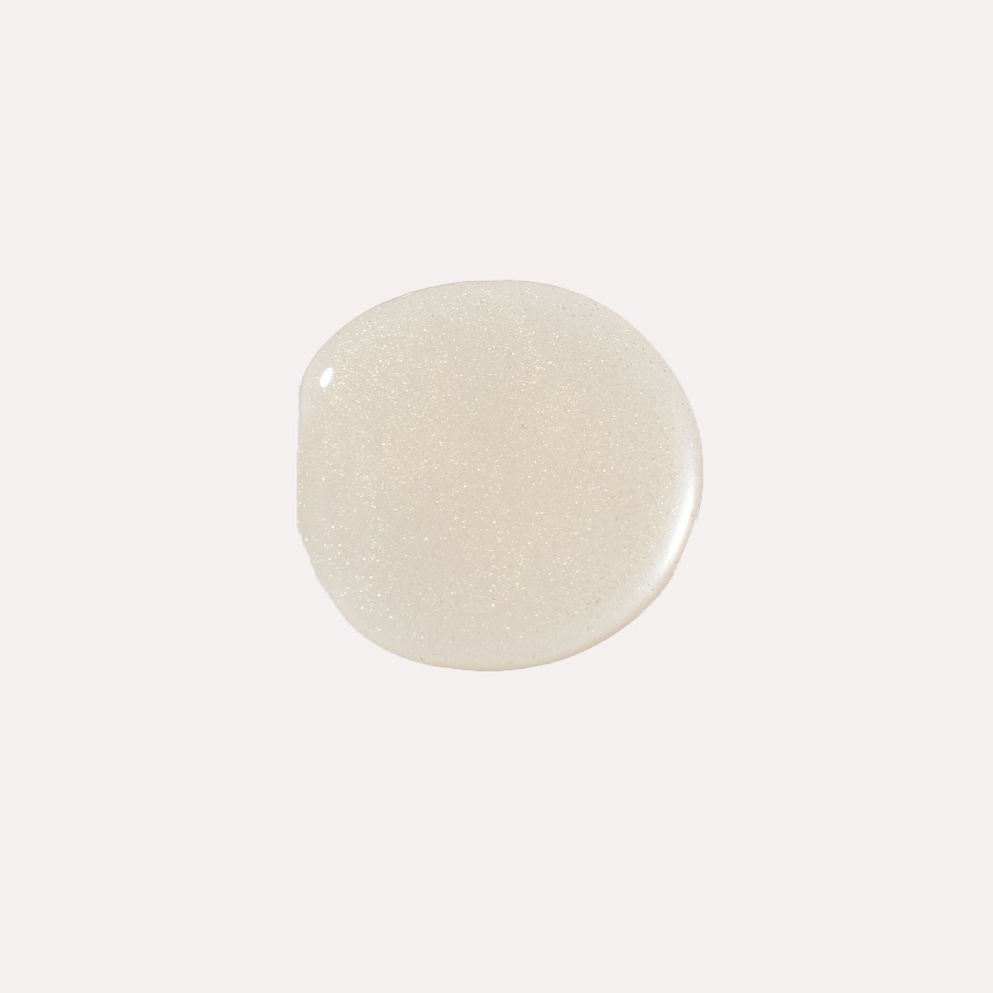 Clear, glossy lip oil swatch with pale pearly sheen