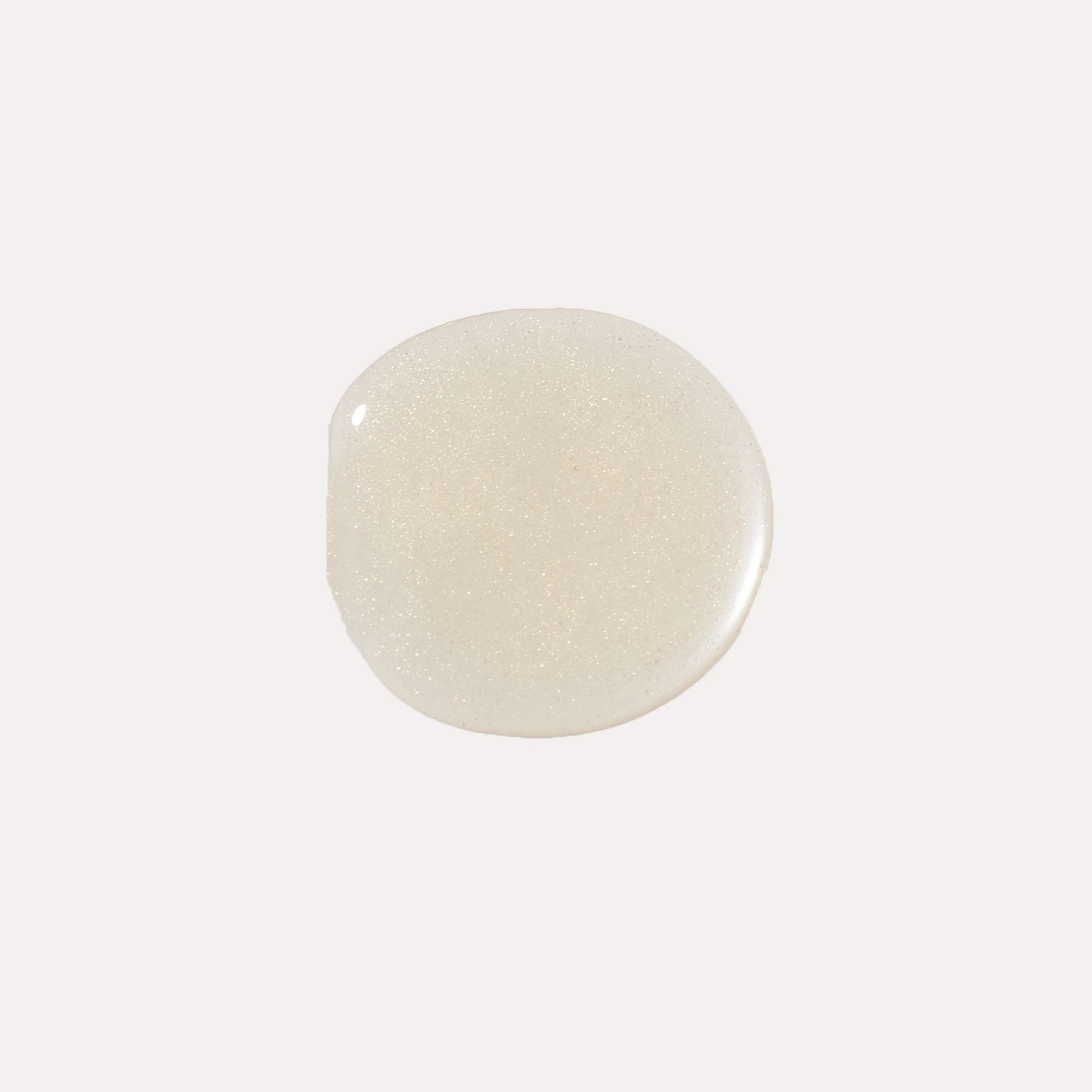 Clear, glossy lip oil swatch with pale pearly sheen
