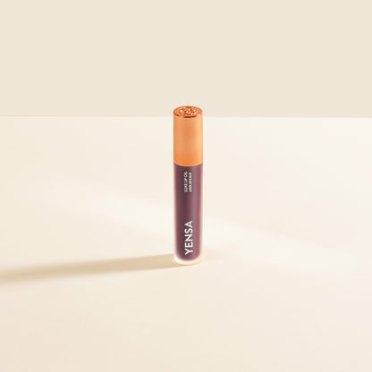Dark berry lip nourishing oil in tube with gold cap and YENSA logo