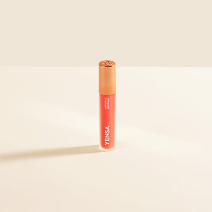 Coral-red lip nourishing oil tube with gold cap and YENSA branding