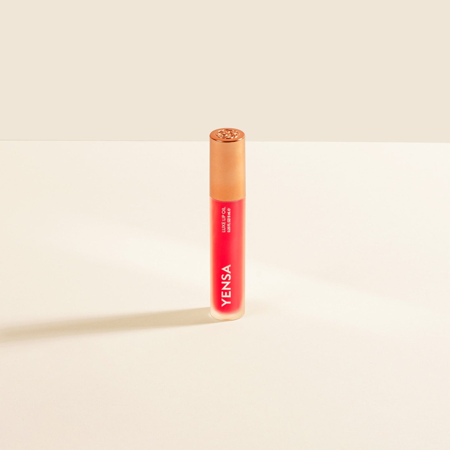 Red lip nourishing oil tube with gold cap and YENSA branding
