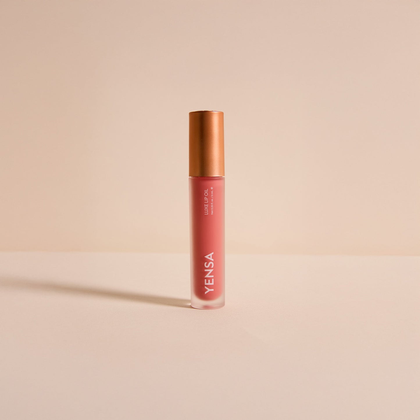 YENSA lip oil bottle with rose-gold cap, rose-pink tinted gel