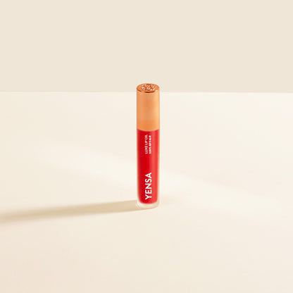 Red lip nourishing oil in clear tube with gold cap and YENSA label