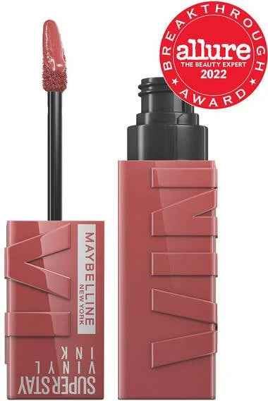 Maybelline Vinyl Ink liquid lipstick in dusty rose with applicator wand and badge.