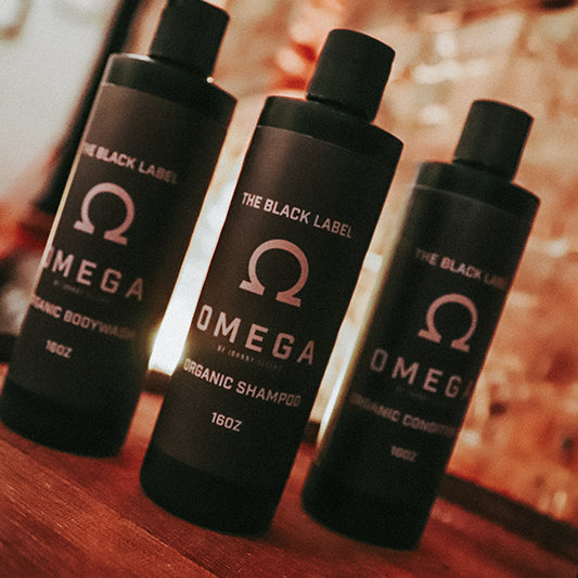 Three dark amber conditioner bottles with caps, Omega branding, Organic Conditioner