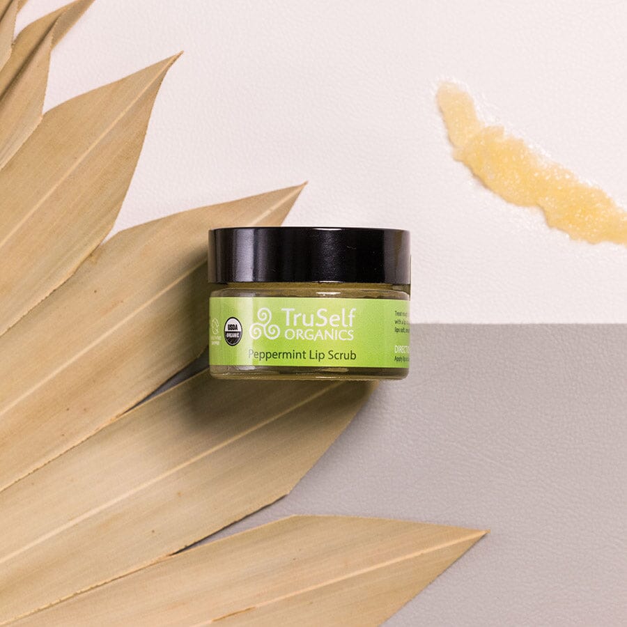 Lip scrub jar: TruSelf ORGANICS peppermint scrub with black lid and green label.
