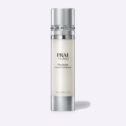 Serum bottle with jeweled band and silver cap, PRAI beauty Platinum Firm & Lift Serum, 118 mL