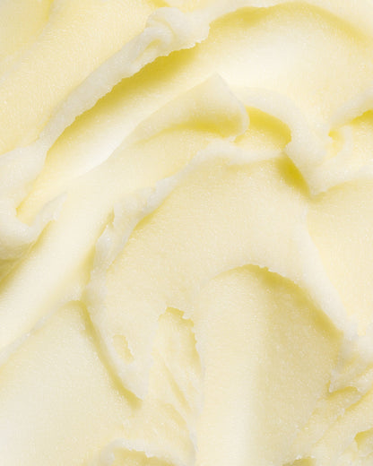 Close-up of creamy tallow balm texture with pale yellow sheen