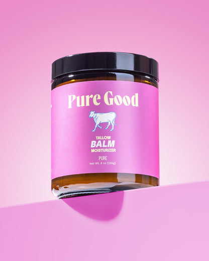 Tallow balm jar close-up, pink label with goat icon, black lid