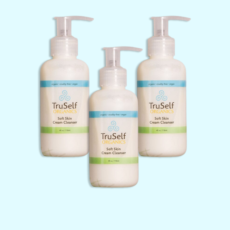Set of three cream cleanser pump bottles, white containers with green label strip