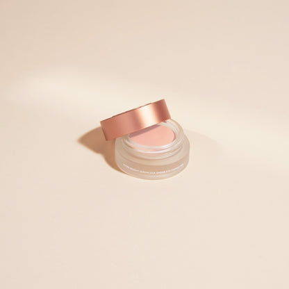 Under-eye serum jar with rose-gold lid, creamy corrector product inside